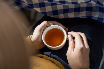 Person drinking tea, elevated view