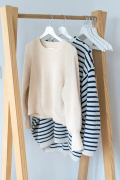 Pullovers hanging on clothes rack
