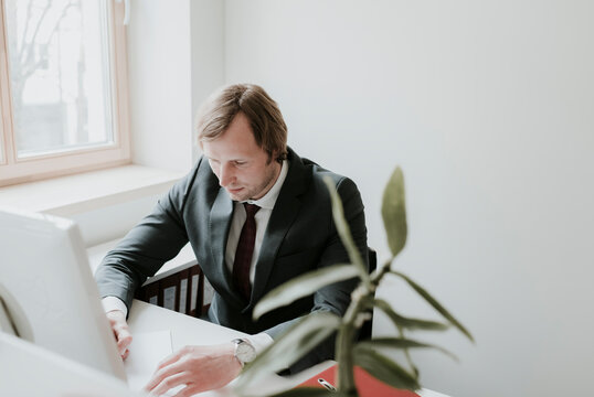 Businessman using computer at desk in office