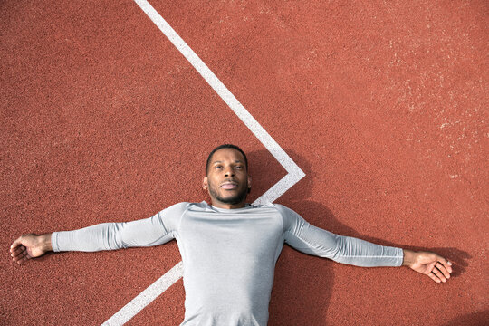 Sportsman lying on racetrack
