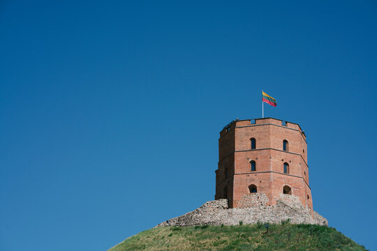 Low angle view of Gediminas Tower on hill against clear blue sky