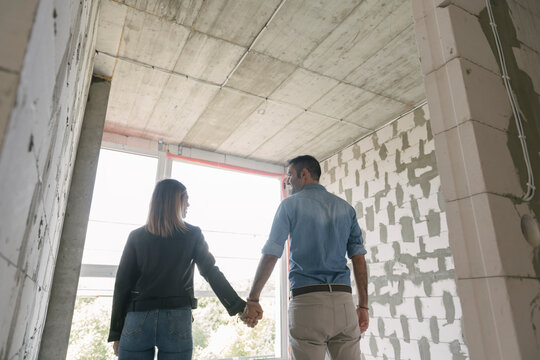 Happy couple of future owners at construction site