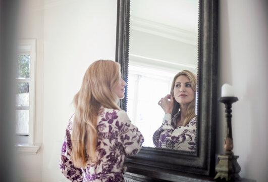 Woman checking make up in a mirror