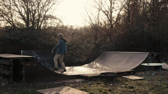 Drone Shot Of Skateboarder Skating Mini Ramp In Backyard Garden Autmn Sunset Shot In 4k