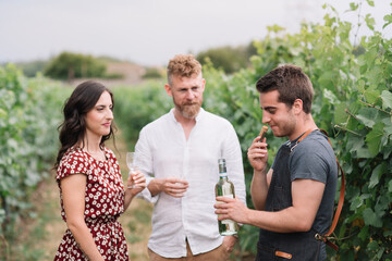 Sommelier smelling wine cork from freshly opened bottle in the vineyard