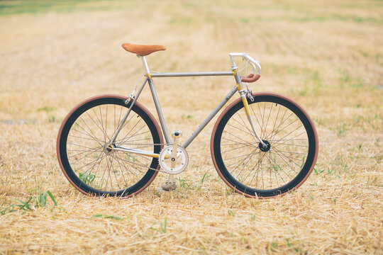 Handcrafted racing cycle on stubble field