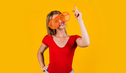 Smiling Woman pointing finger up. Sale and discount. Season sales. Funny girl showing free space, place for Advertising.