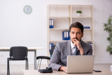 Fototapeta premium Young male employee and too much work in the office