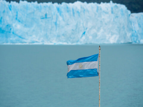 Argentina, Patagonia, El Calafate, Argentinian Flag with Glacier Perito Moreno in the background