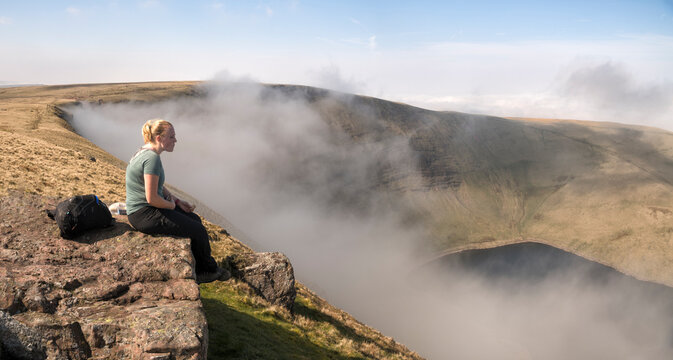 UK, Wales, Brecon Beacons, Young woman hiking at Bannau Sir Gaer Ridge