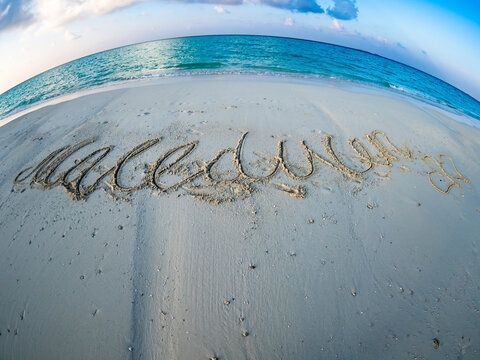 Maledives, Ross Atoll, beach with writing