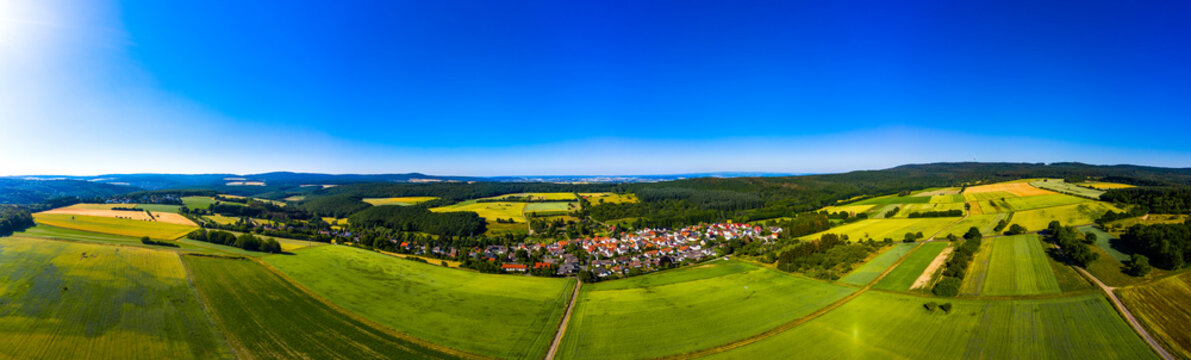 Aerial view over grain fields, meadows, woods and villages, Wetterau, Germany