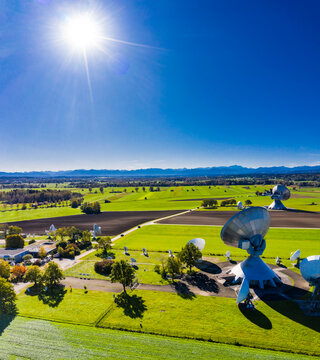 Germany, Bavaria, Aerial view of large parabolic antennas of the earth station Raisting and green fields