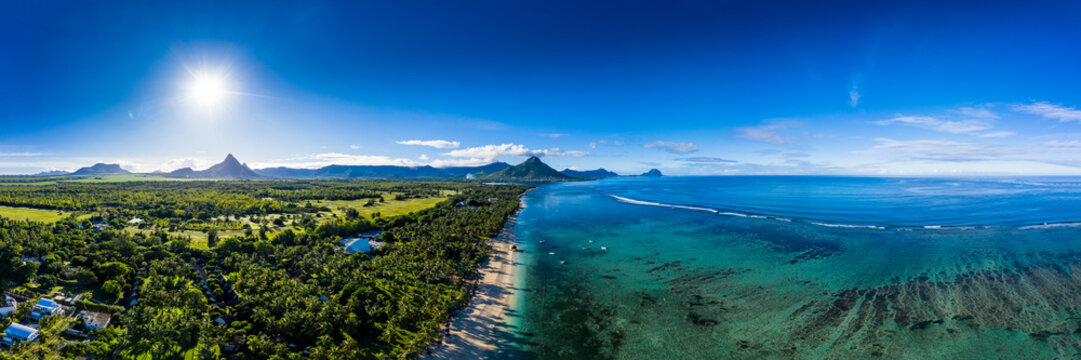 Mauritius, Black River, Flic-en-Flac, Aerial panorama of sun shining over palm trees along coastal beach in summer