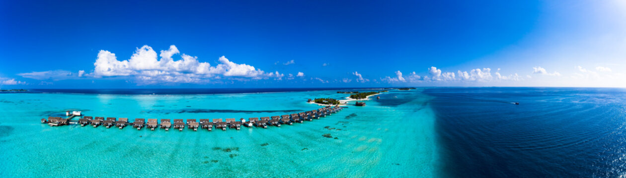 Maldives, Aerial view of resort stilt houses on Maadhoo island in summer