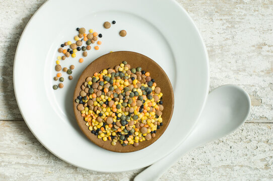 Plate of lentils on wooden table seen from above