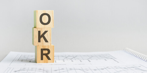 the word OKR structured query language, lined with wooden blocks