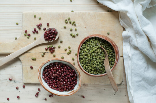 Split beans and Adzuki beans on wooden background