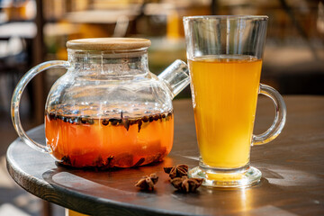 ..Organic hot tea with lemon and herbs in cup.