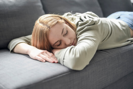 Portrait Of Blond Young Woman Napping On The Couch