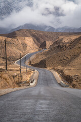 Dispersed fog at the end of the path after a light snowfall. wild road, journey and new discoveries. Travel is the meaning of life