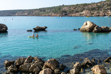 Crystal clear blue water of Mediterranean sea  and yellow rocks in on Konnos beach near Protaras, Cyprus