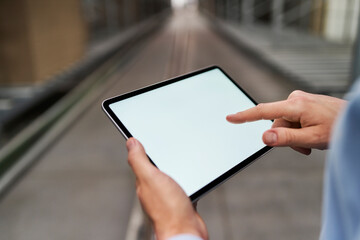 Close-up of businessman using tablet in factory
