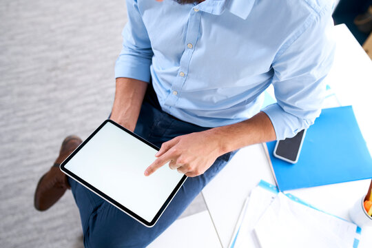 Overhead view of a businessman using a digital tablet
