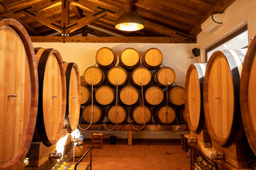 White, rose and red wine in barrels for sale in wine cellars in Italy