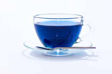 Cup of Anchan or Butterfly pea tea. Blue tea in a transparent glass cup isolated on white background
