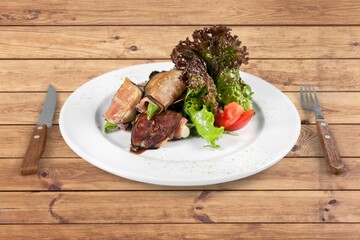Tasty fresh hot dish and salad on the plate