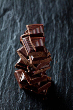 Pile of chocolate pieces on black slate