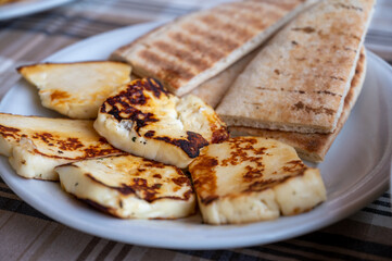Traditional roasted or grilled halloumi cheese from Cyprus served hot with flat bread
