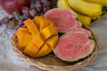 Exotic fruits of Cyprus, fresh ripe pink guava, yellow juicy mango, bananas and sweet table grapes