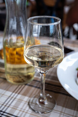 Dinner with white wine in small Greek taverna
