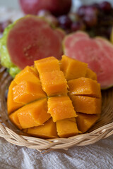 Exotic fruits of Cyprus, fresh yellow juicy mango, ripe pink guava, bananas and sweet table grapes