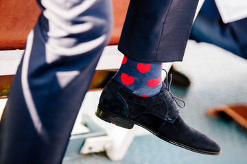 Low section of man wearing socks with heart shape in ceremony