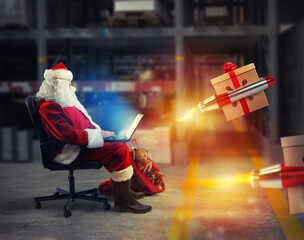 Santa claus delivers online orders from a laptop