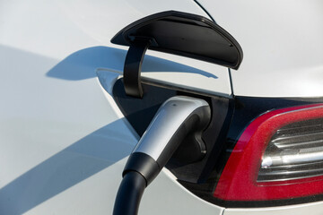 Charging electric car in residential garage.