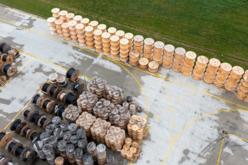 A huge number of wooden coils with polypropylene pipes. Production and storage of polypropylene pipes for urban communications. View from above