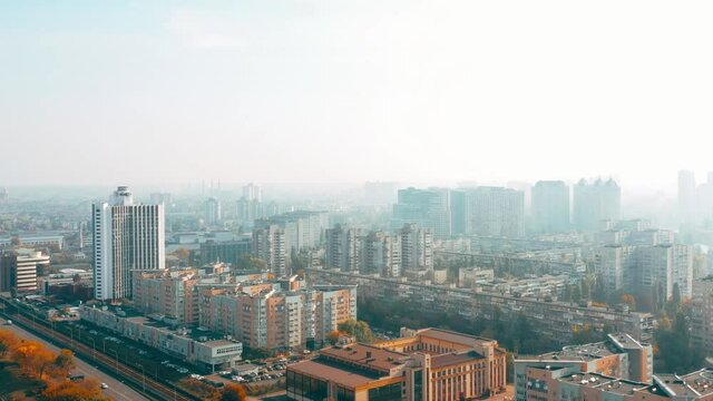 View from a height of the foggy city and residential buildings in autumn