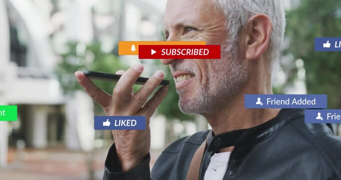 Animation of social media icons over senior man using smartphone