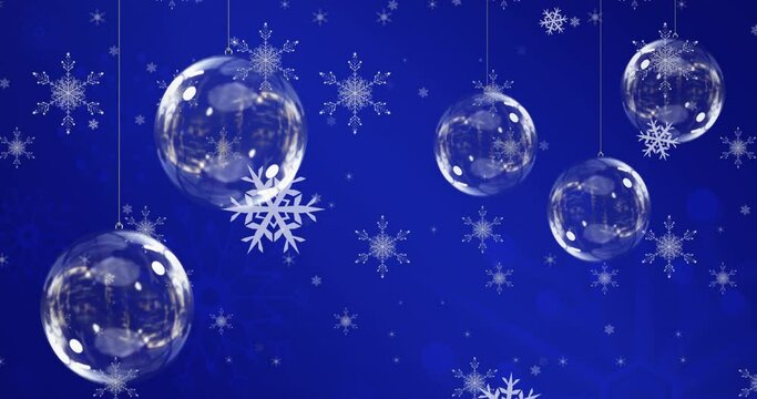Animation of christmas balls over snowflakes on blue background