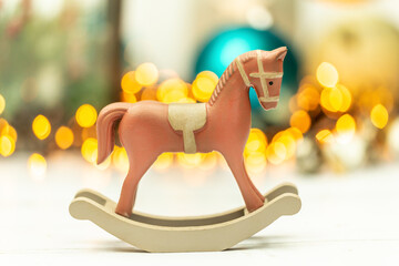 Christmas decoration: Close-up of  a rocking horse in front of a modern christmas bokeh background
