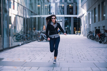 Woman with sunglasses running away