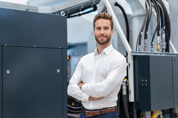 Portrait of a confident businessman in a modern factory