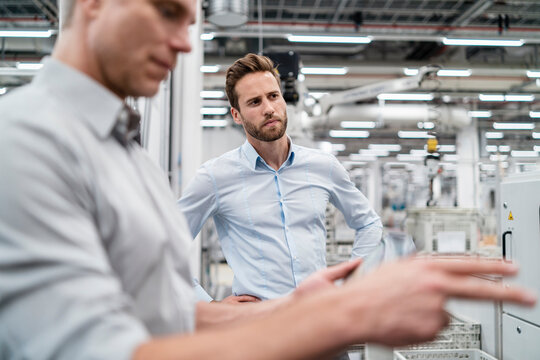 Two businessmen in a modern factory