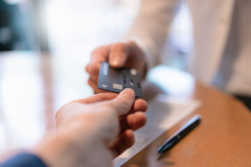 Customer paying bill with credit card, close-up