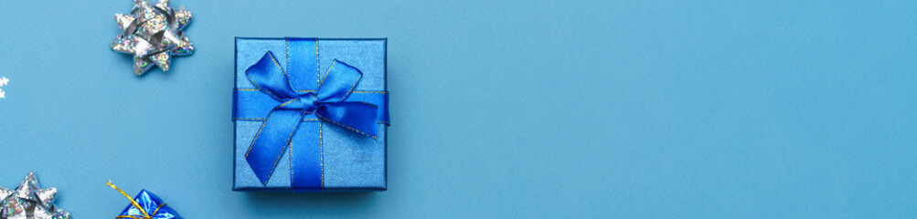 Blue christmas background of gift box and snowflake decorations and balls of blue and silver color....