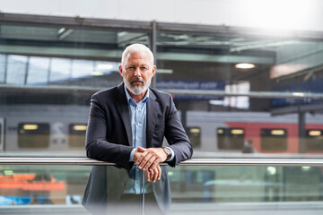 Portrait of mature businessman at the station platform
